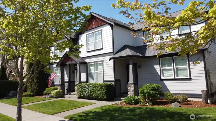 Impressive exterior with mature landscaping, washed aggregate walkways, designer paint, covered front entry, and rear patio with cover.
