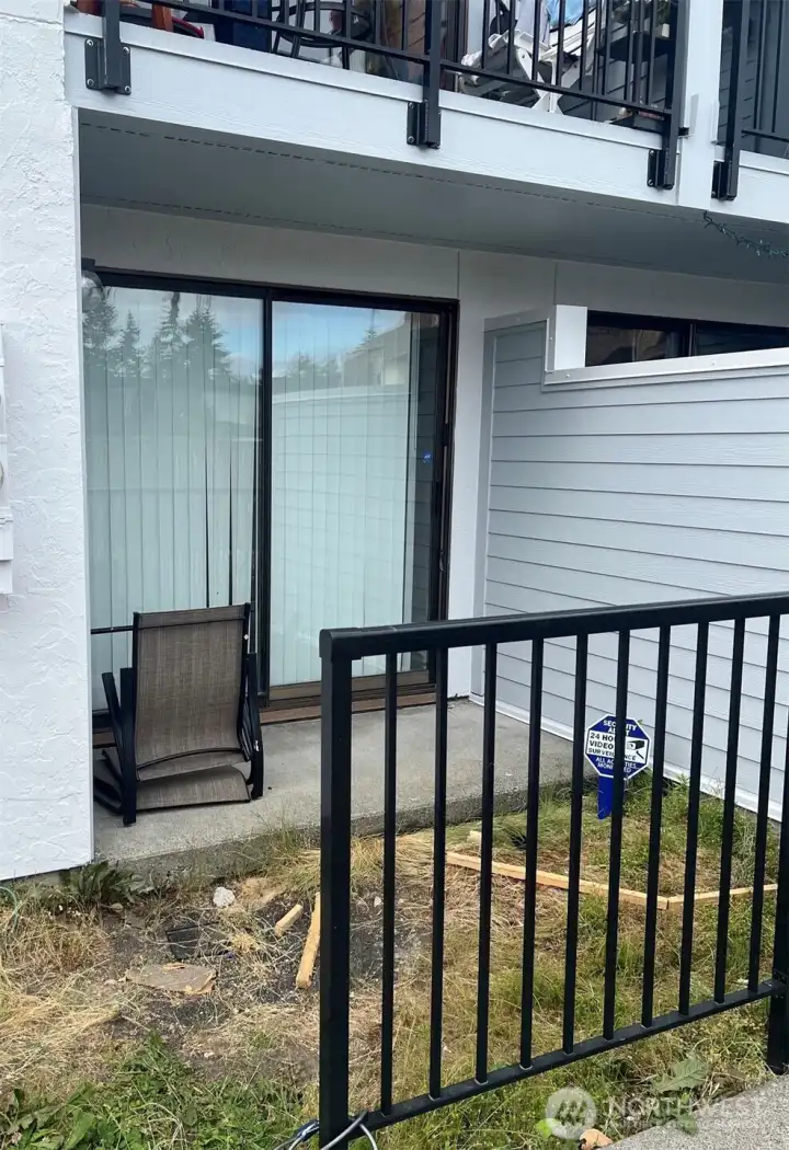 Front private patio with slider doors.