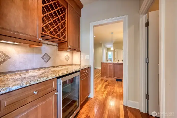 A sophisticated butler’s pantry with wine refrigerator and an oversized walk-in pantry adds both luxury and practicality, creating an ideal space for entertaining and organization. A sophisticated butler’s pantry with wine refrigerator and an oversized walk-in pantry adds both luxury and practicality, creating an ideal space for entertaining and organization.