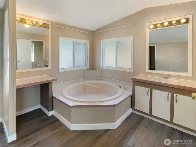 Relaxing primary bath offers dual vanities, shower and a garden tub to soak your troubles away after a long day!
