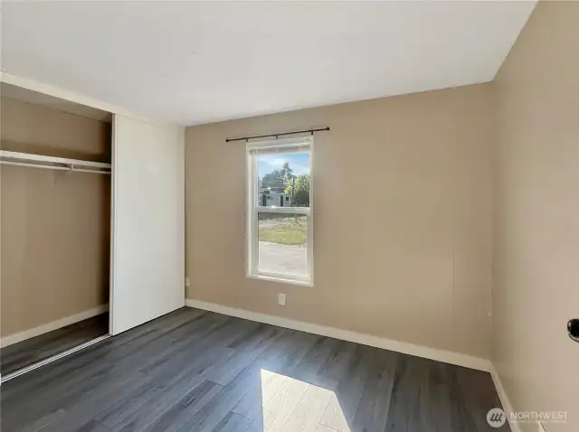 Guest bedroom located opposite the primary bedroom in this split-bedroom floor plan.
