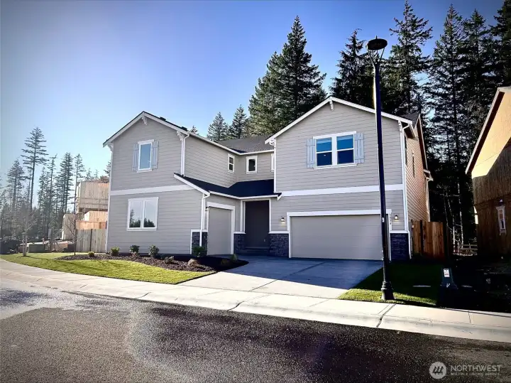 New NexGen home- 3 car garage backing up to green space.