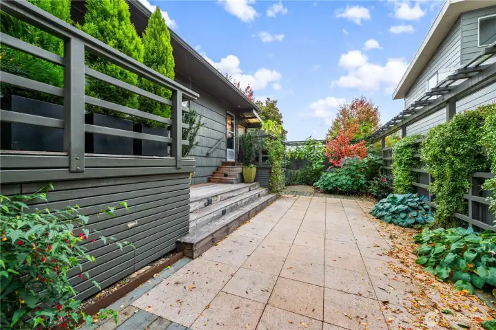 Yard features two decks and complementary Pergola
