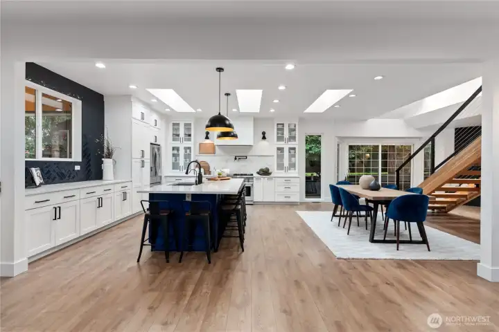 Gormet Chefs kitchen with expansive island with gorgeous waterfall quartz countertop!