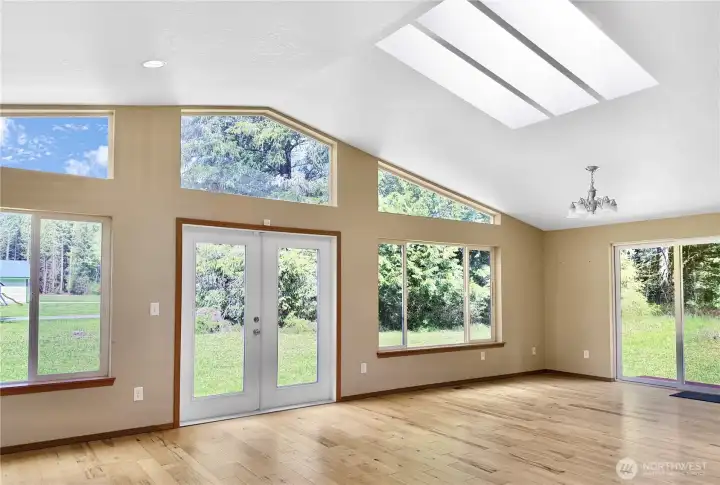 Natural light pours through the large windows, framing the peaceful setting outside and making the heart of the home feel warm, open, and inviting.