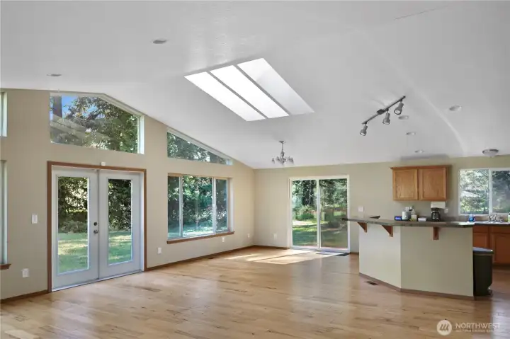 The back of the home showcases the dramatic windows, vaulted roofline, and indoor-outdoor connection — a home designed to soak in the beauty of its 5-acre setting.