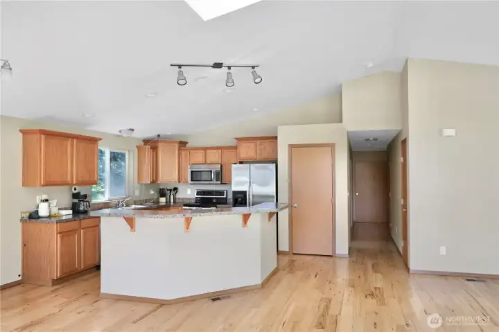 A warm, welcoming kitchen with plenty of counter space, beautiful wood cabinetry, and a natural flow into the living area — perfect for morning coffee, casual meals, and gathering with friends.