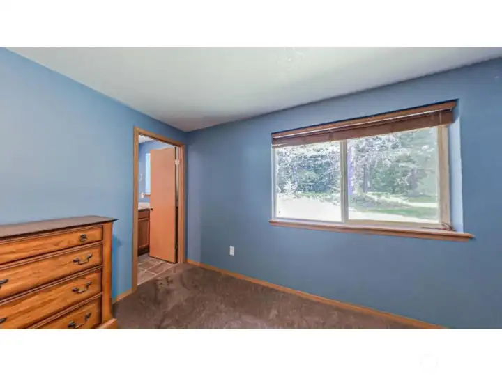 Primary Bedroom with Ensuite Access  Relax and unwind in the primary bedroom complete with convenient ensuite bath access and a thoughtful layout for everyday comfort.