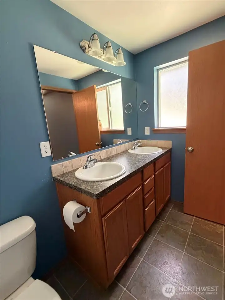 Clean, comfortable, and functional, this full bath offers a fresh neutral palette, tile flooring, and a spacious vanity for easy everyday living.