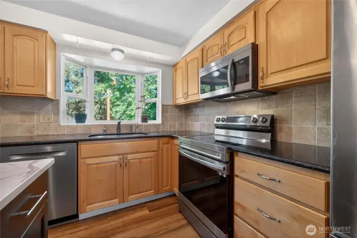 Custom cabinetry and elegant Cambria quartz countertops elevate the space. Custom cabinetry and elegant Cambria quartz countertops elevate the space.