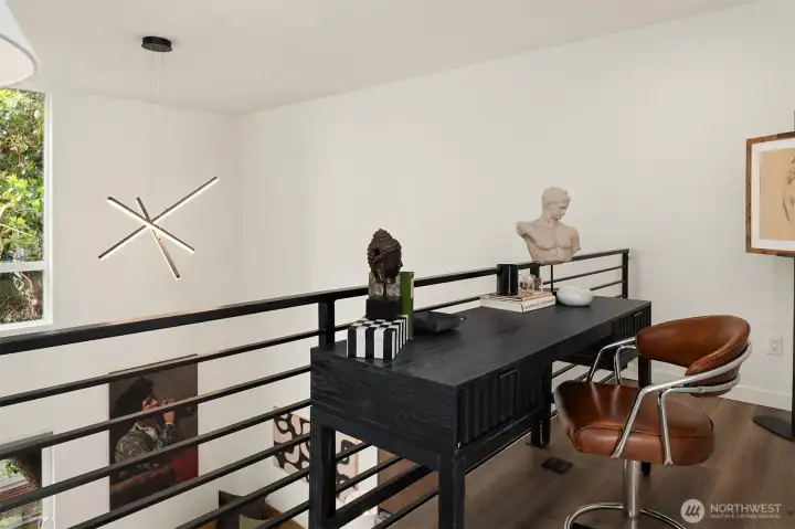 A lofted office overlooking the main living area provides a bright and inspiring workspace filled with natural light. A lofted office overlooking the main living area provides a bright and inspiring workspace filled with natural light.