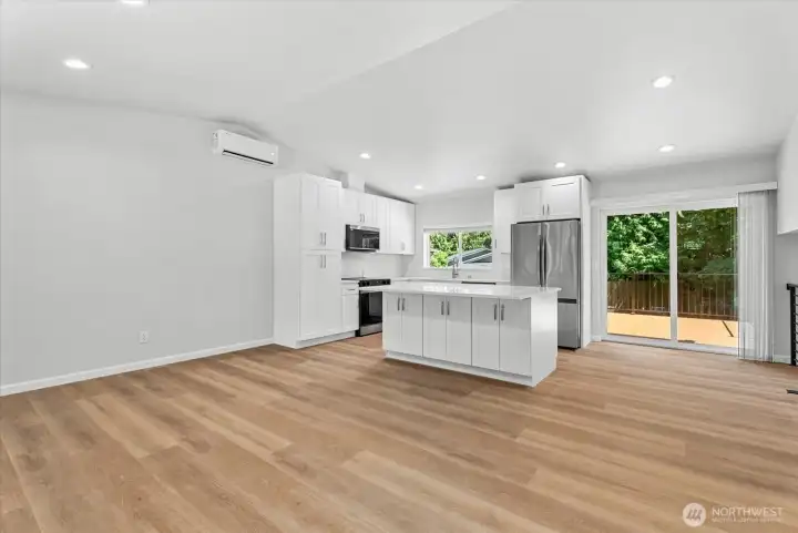 Open kitchen and living room with vaulted ceilings Open kitchen and living room with vaulted ceilings