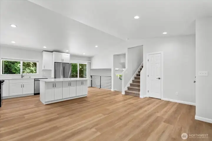 Open kitchen and living room with vaulted ceilings Open kitchen and living room with vaulted ceilings