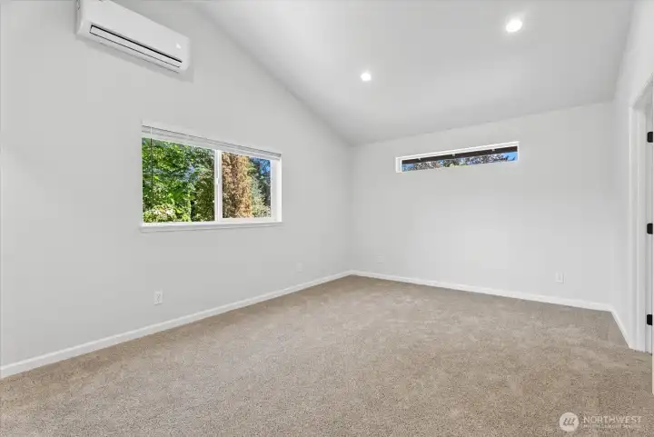 Primary bedroom with vaulted ceiling Primary bedroom with vaulted ceiling