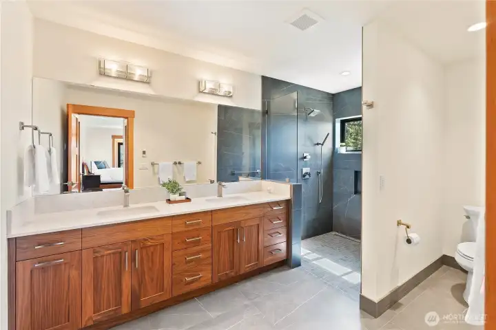Stunning primary bathroom with radiant floor heat, custom tile and quartz coutnertops