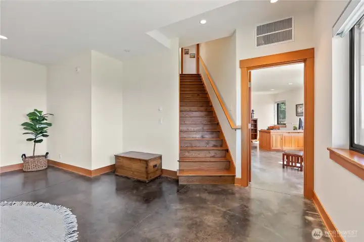 Stained concrete slab flooring throughout the basement with more of that gorgeous fir trim.