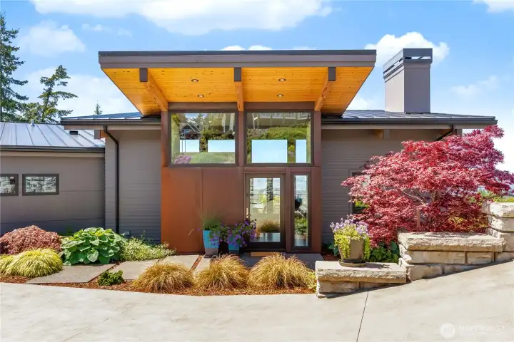 Stunning entry with Corten Steel accent and a vaulted covered front porch