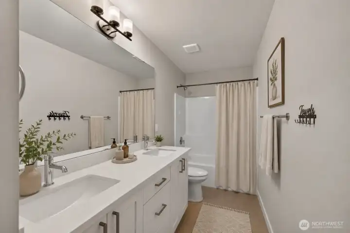 virtually staged - upper level full bath with dual sinks