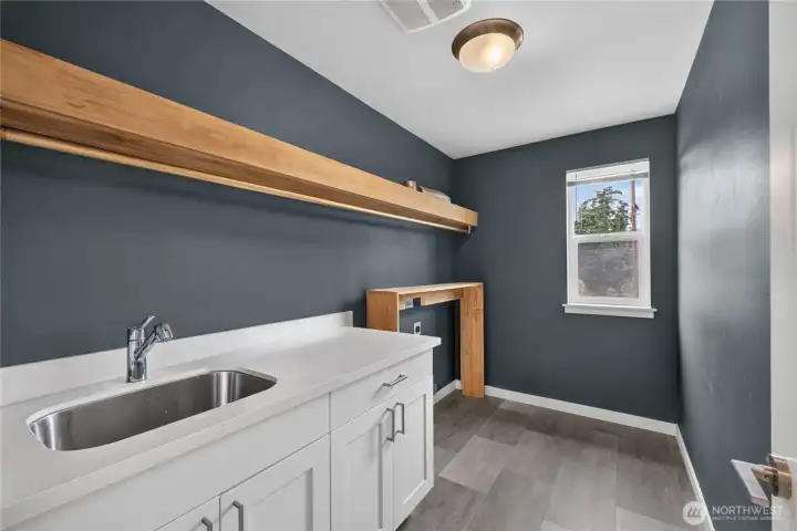 Upper level laundry room with sink