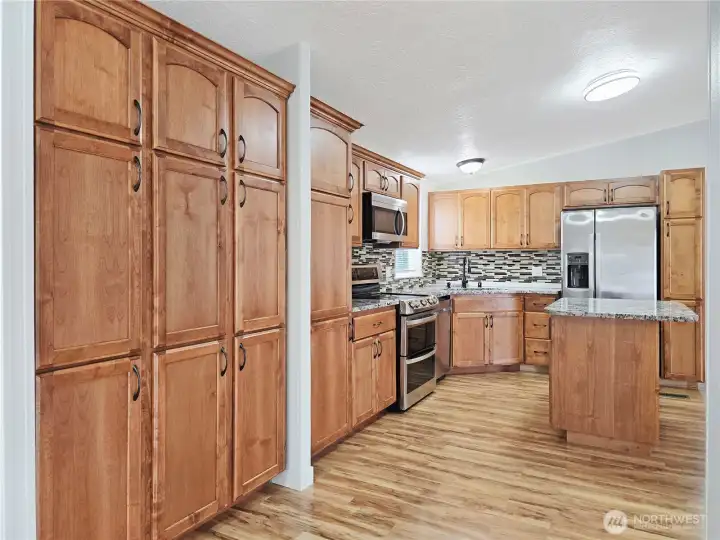 Floor-to-ceiling pantry cabinets provide impressive storage and organization.