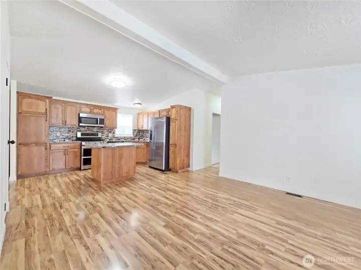 Comfortable gathering room just off the kitchen creates the perfect space for casual living, movie nights, or keeping everyone connected while meals are prepared.