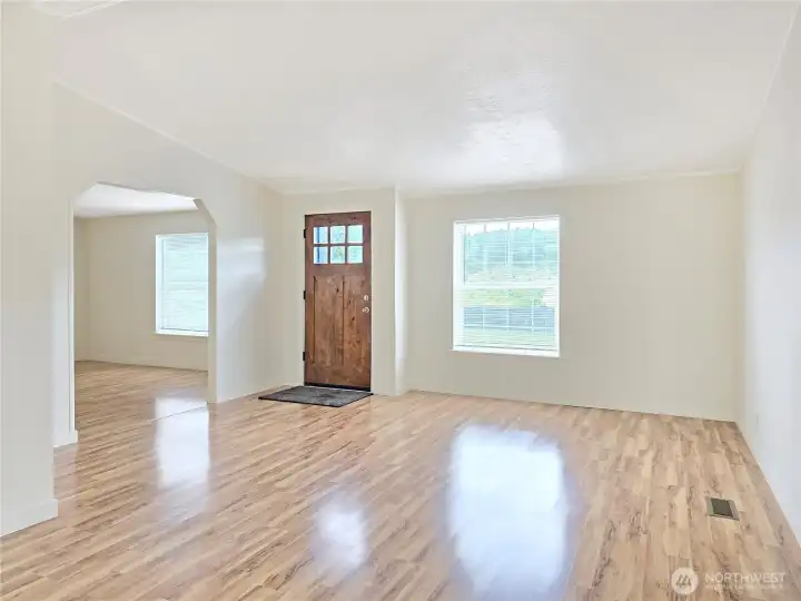 Open living and dining areas create a spacious, inviting setting for everyday living and entertaining. Crafted wood front door serves as a beautiful focal point in the living room.