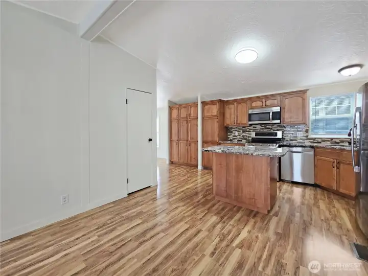 The gathering room just off the kitchen creates the perfect space for casual living, movie nights, or keeping everyone connected while meals are prepared.