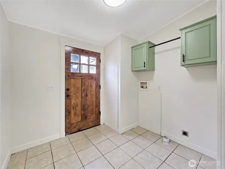 Tile flooring provides a practical, low-maintenance finish in the laundry area.