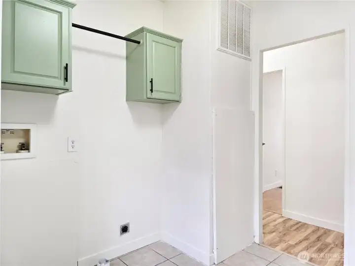 Functional laundry room featuring additional storage and direct access to the outdoors.