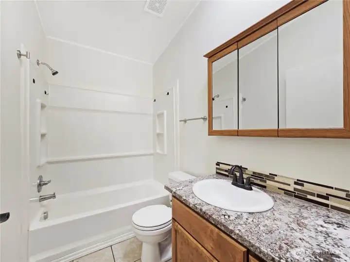 Well-appointed full hall bath conveniently located to serve the secondary bedrooms and guests.