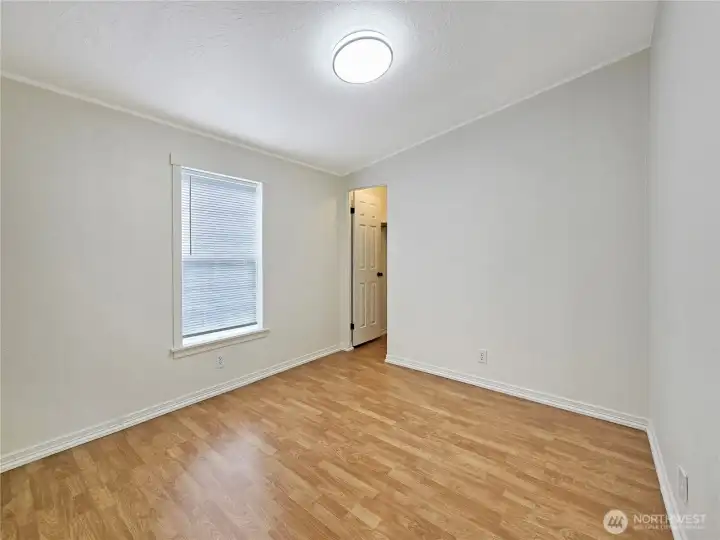 Versatile third bedroom with a walk-in closet, perfect for guests, a home office, or hobbies.