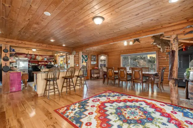 Open floor plan with beautiful hardwood floors and warm wood interior