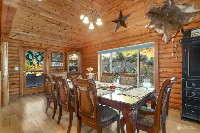 Dining space off of the kitchen with vaulted tounge & groove ceiling. Door leads to back deck.