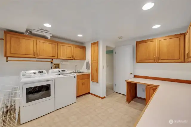 Laundry room on the lower level is large and has plenty of storage and folding surface.