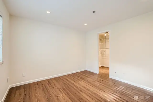 Another view of the primary bedroom facing the walk-in closet.