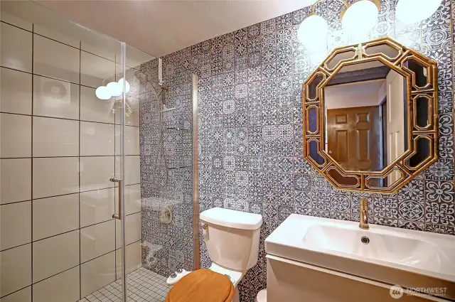 Fully remodeled bathroom with floor to ceiling tile.