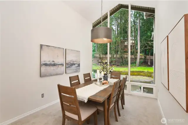 Formal dining area has oversized windows too.