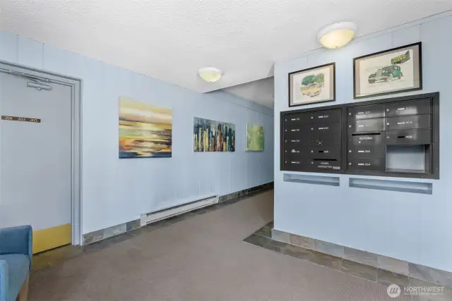 Secure lobby with mailboxes and a great community board with information around the corner.