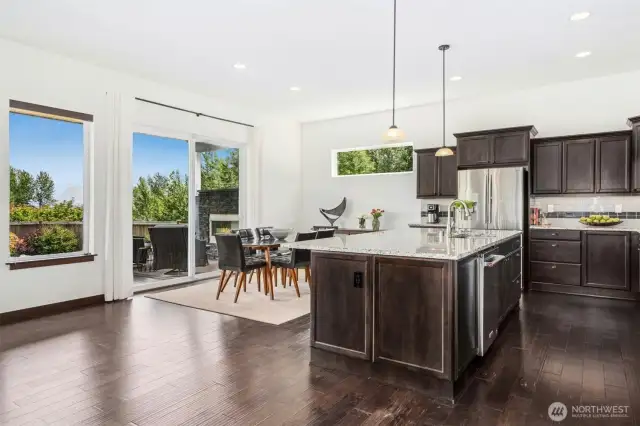 Elegant dining area that flows out onto the expansive covered composite deck with outdoor fireplace & patio