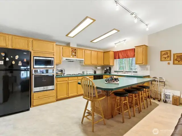 The open-concept kitchen is designed with both functionality and flow in mind, making everyday cooking a breeze.