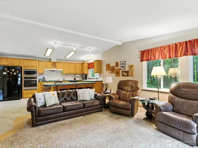 The bright and casual living space seamlessly merges the kitchen and family room, creating a welcoming and connected atmosphere.