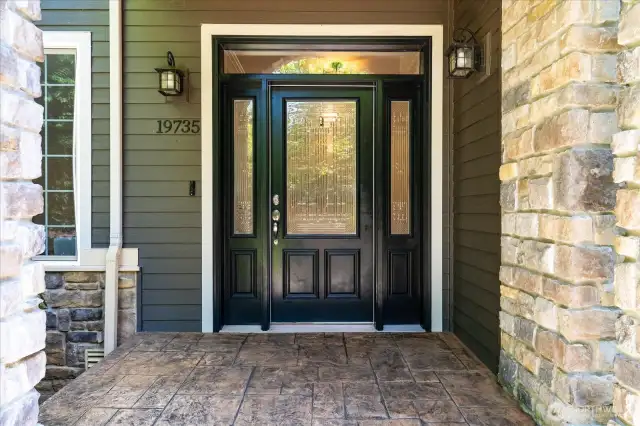 Welcoming covered entrance to greet your guests, with stamped concrete steps and landing