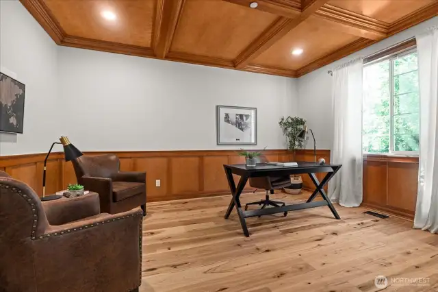 Large main floor den with double door, warm wood wainscoting and box ceiling