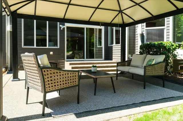 Covered pergola on back patio offers year-round outdoor enjoyment