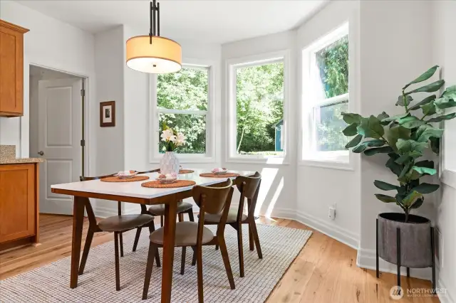 Sunny eating nook off kitchen with bay window offers pleasant backyard views