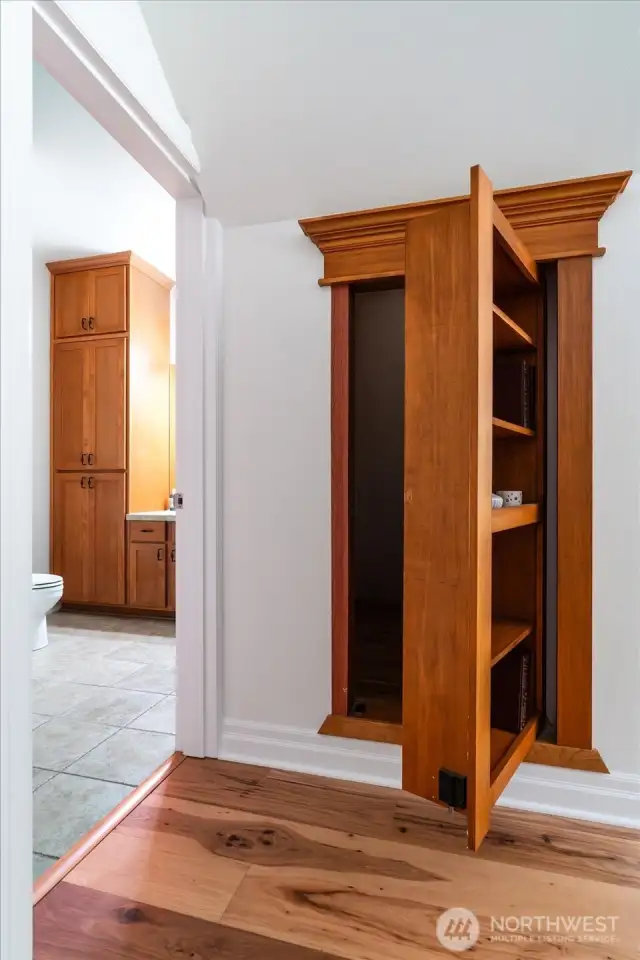 Secret storage closet hidden behind revolving bookcase