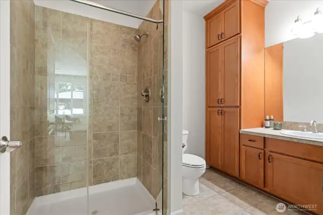 Main 3/4 bath offers large walk-in tiled shower, and vanity with exceptional storage space