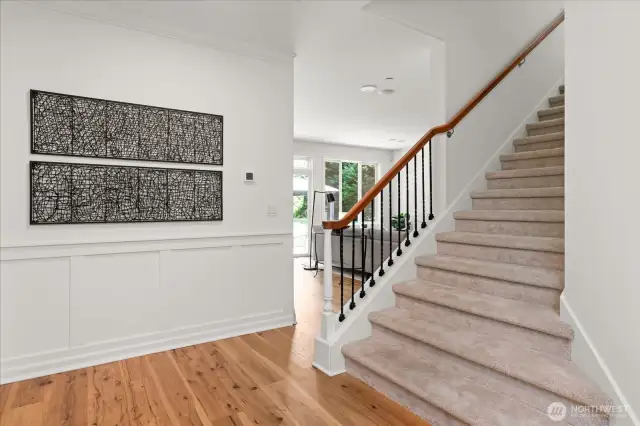 Wide staircase with lower open spindles, guide you to the upper floor