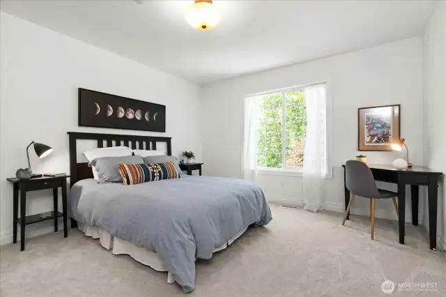 Generously sized additional secondary bedroom offers space for queen sized bed, dresser and desk.