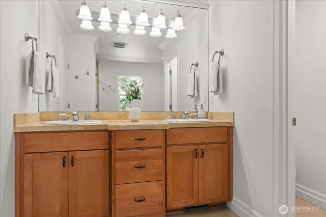 Primary bath offers dual sinks and large mirror